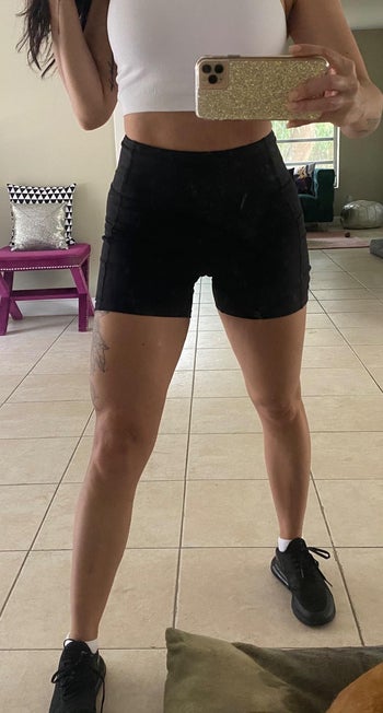 reviewer taking a selfie in black biker shorts