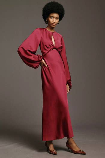 model in red maxi satin dress