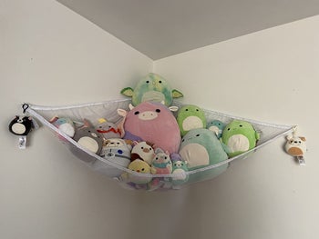 Reviewer's photo showing a white hammock holding stuffed animals