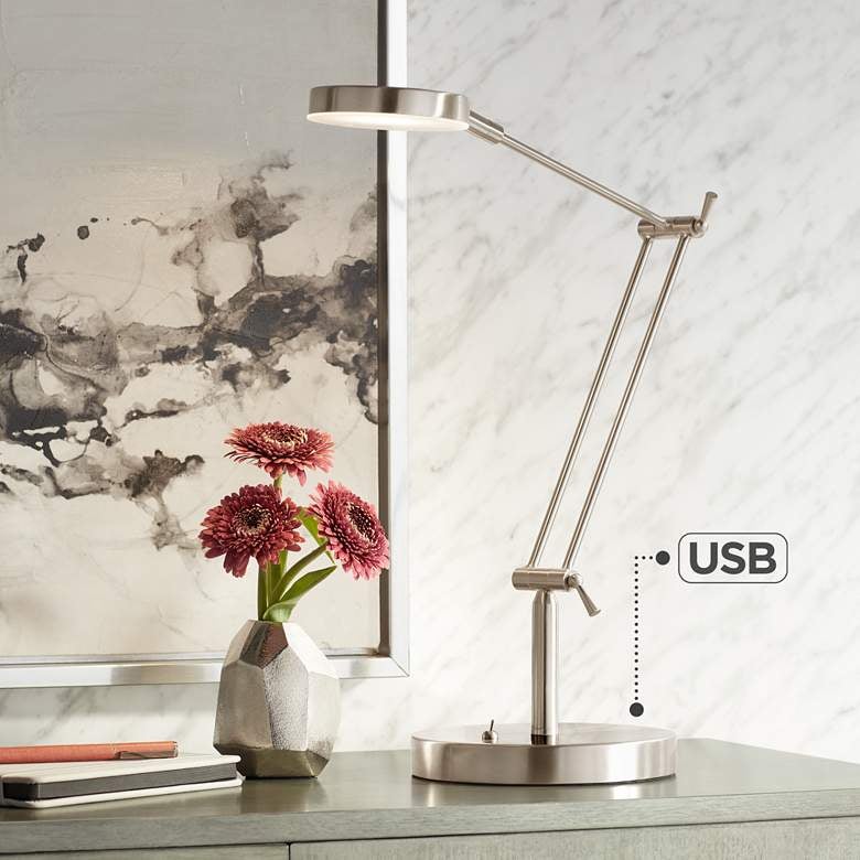 a metal desk lamp with an infographic indicating where its USB port is on its base