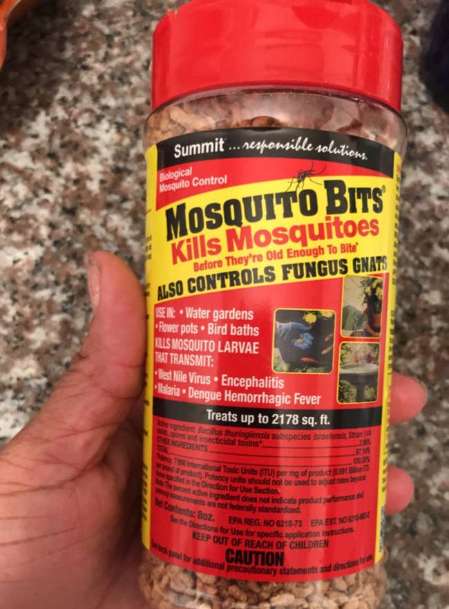 Reviewer holding bottle of mosquito bits