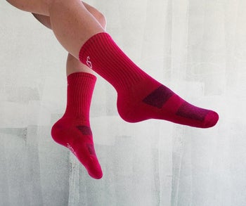 a model wearing the socks in red