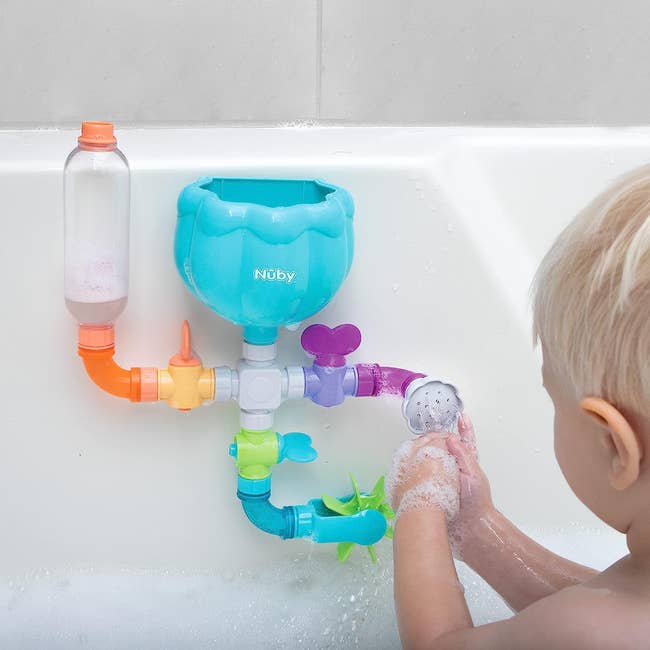 a water toy of pipes and shower heads for the tub