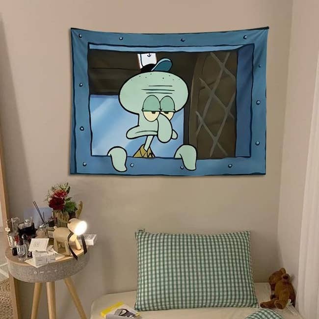 a tapestry of Squidward from SpongeBob looking out of his cashier window at The Krusty Krab