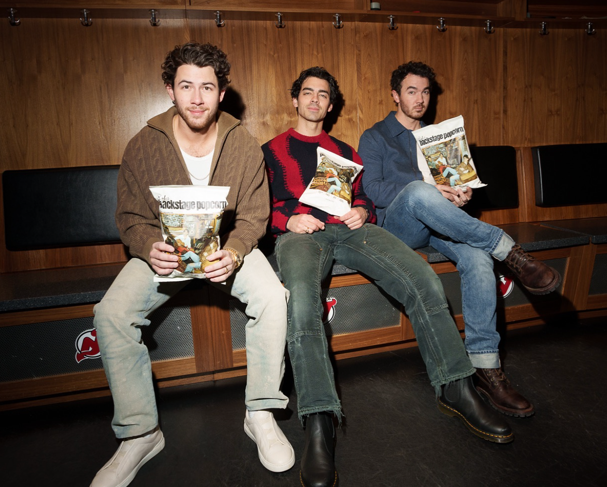 photo of the <b>jonas</b> <b>brothers</b> holding bags of rob&apos;s backstage popcorn.