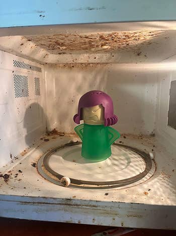 reviewer's filthy microwave with the green and purple Angry Mama inside