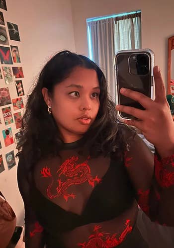 a reviewer in the black and red dragon top