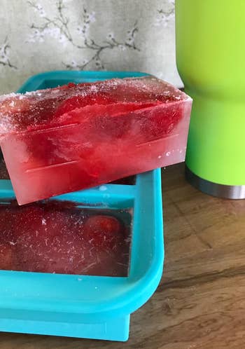 reviewer photo of a blue ice tray with huge red ice blocks in it