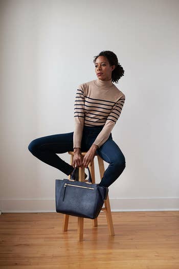 Reviewer wearing the striped black and cream turtleneck sweater