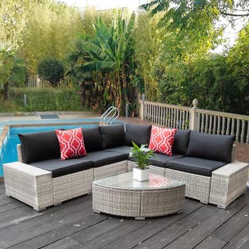 black and gray outdoor sectional with wedge table on a deck