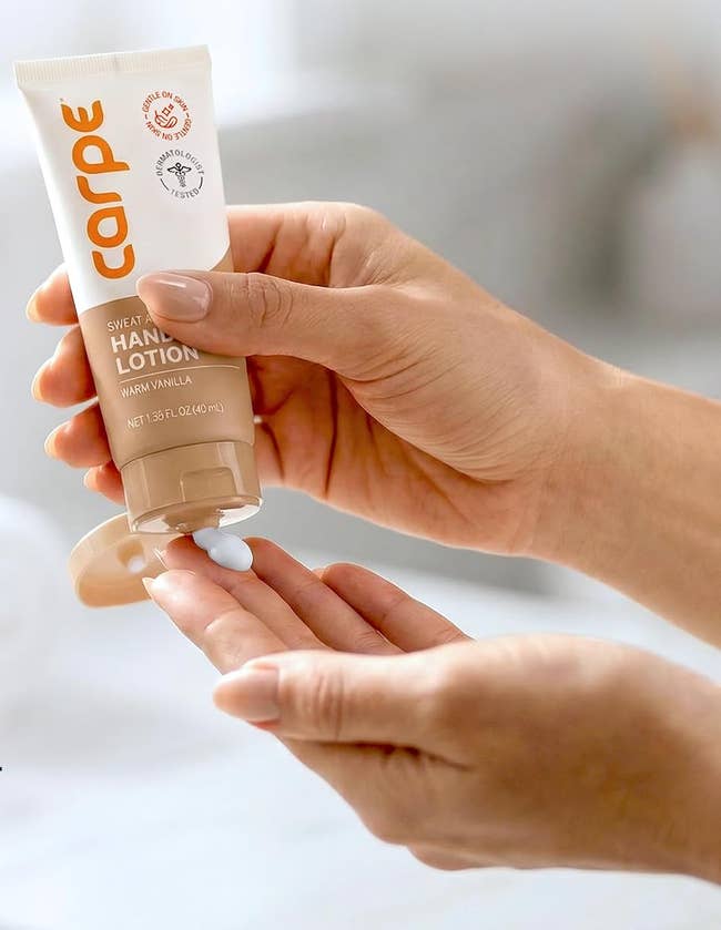 Hands applying a tiny magnitude of Carpe sweat-absorbing manus lotion, labeled