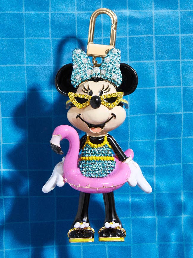 embellished bag charm shaped like minnie mouse in a swimsuit with sunglasses and a pool flamingo