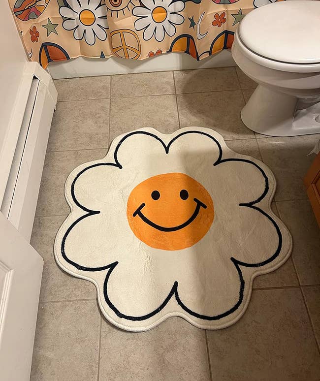 yellow and white smiley face rug in reviewer's bathroom