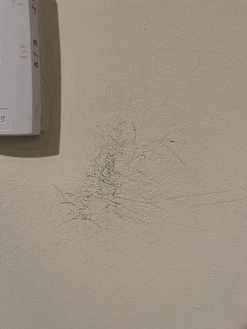 reviewer image of wall with scratches on it