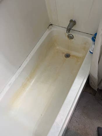 reviewer before image of a white bathtub stained yellow and orange