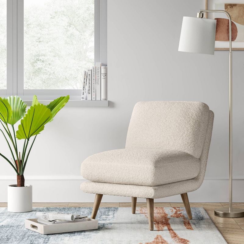 white sherpa slipper chair on rug in living room