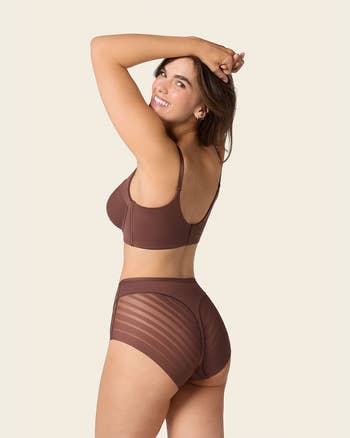 model wearing the brownish  underwear shown from the back