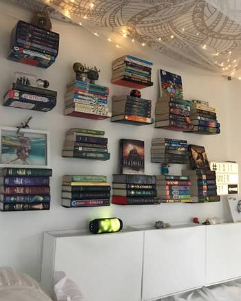 another reviewer's wall full of 14 floating shelves all holding a set of books