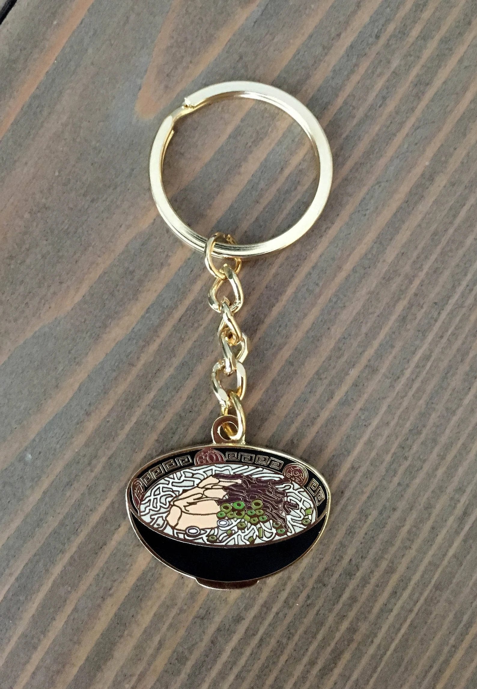 Black metal keychain designed as bowl of ramen
