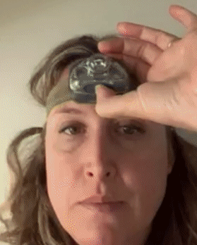 gif of reviewer wearing the headlamp and turning the light on and off