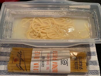 reviewer raw pasta next to pasta container with water and cooked noodles in it
