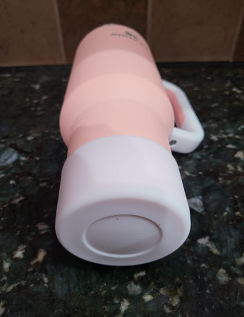 Reviewer image of white boot on pink bottle 