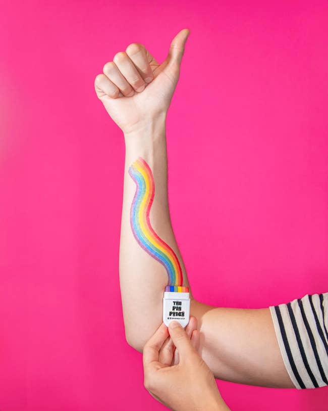 Person showing their forearm with a rainbow painted from a conduit labeled