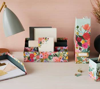 a desk with a floral print desk organizer on it 