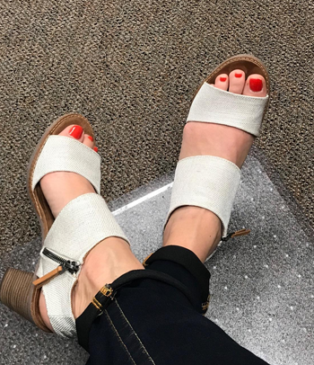 overhead view of reviewer wearing the white sandals
