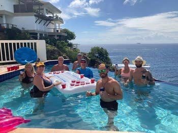 Reviewer pic of several people posing next to the beer pong beer float