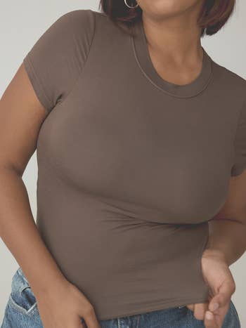 Person successful  a fitted short-sleeve t-shirt and jeans, showing casual attire for shopping