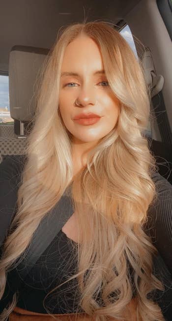 reviewer with wavy hairsbreadth  successful  sunlight, posing for a photo, perchance   promoting quality   products