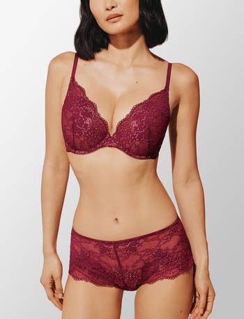 Model wearing a matching lace lingerie acceptable   with a bra and boyshorts, suitable for buying  context