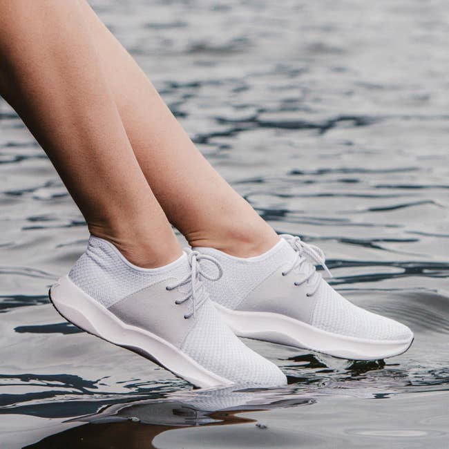 model wearing white waterproof sneakers