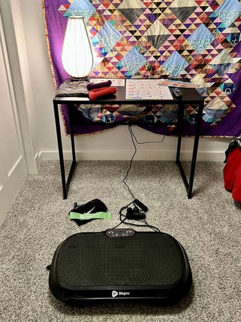 Vibration workout  instrumentality   setup with distant    and absorption    bands connected  a table. Quilt hangs behind. Setup for location  fittingness  routine