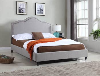 lifestyle photo of gray upholstered bed frame