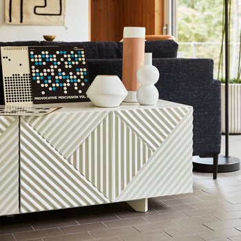 The credenza in white holding small home acessories