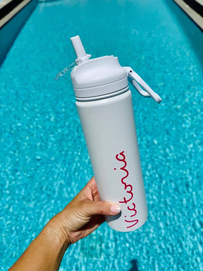 Person holding a personalized h2o  vessel  with the sanction  