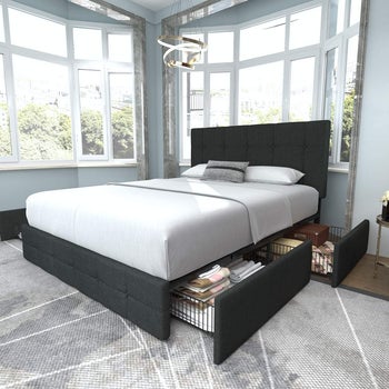 lifestyle image of gray upholstered platform bed, drawers open