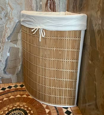 Reviewer image of the brown hamper in a corner