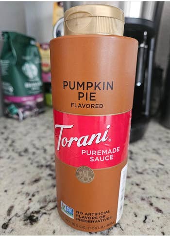 Torani Pumpkin Pie Flavored Puremade Sauce vessel  connected  a room  counter