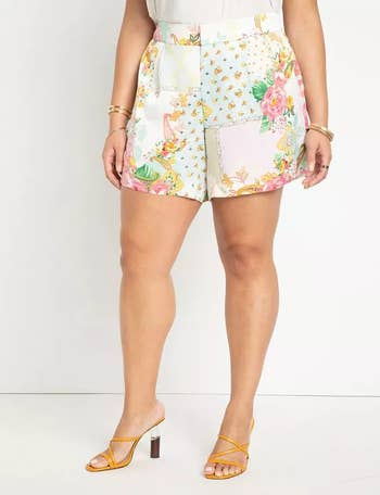 another plus-size model wearing the shorts with a white shirt tucked into it