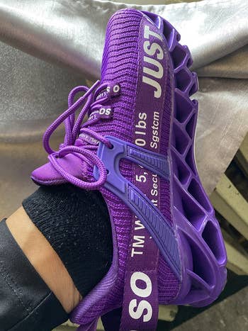 Reviewer wearing purple sneakers