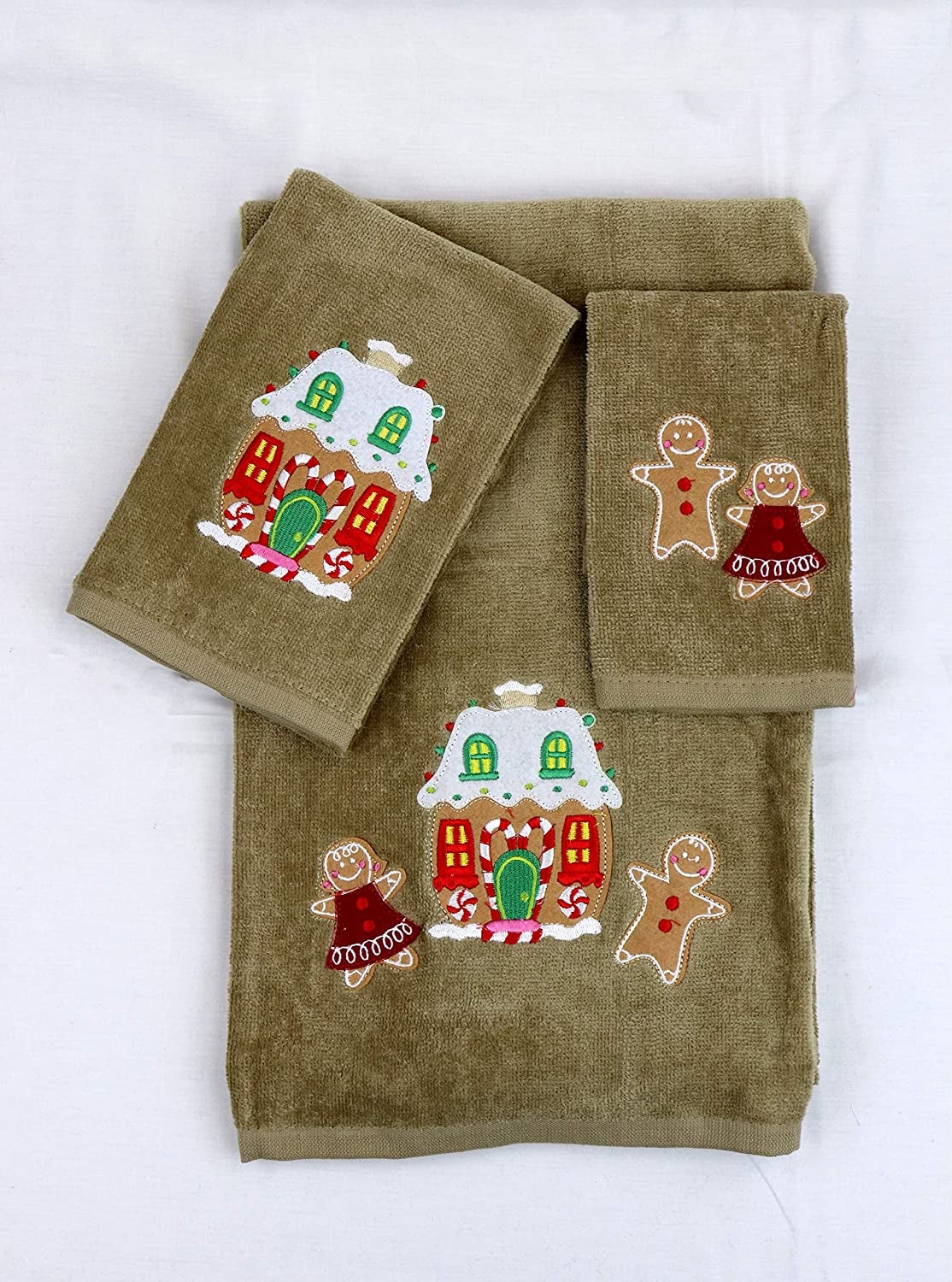 bath towel, face towel, and hand towel with gingerbread folks and houses embroidered on each 