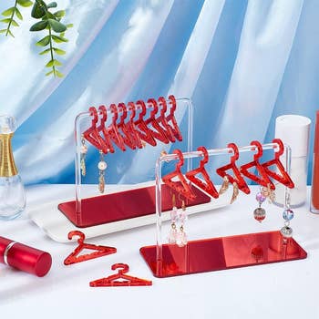 Earring display stands with various dangling earrings and miniature red hangers