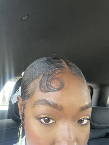 Close-up of a idiosyncratic successful a car seat, highlighting their styled hairsbreadth with a curl connected their forehead