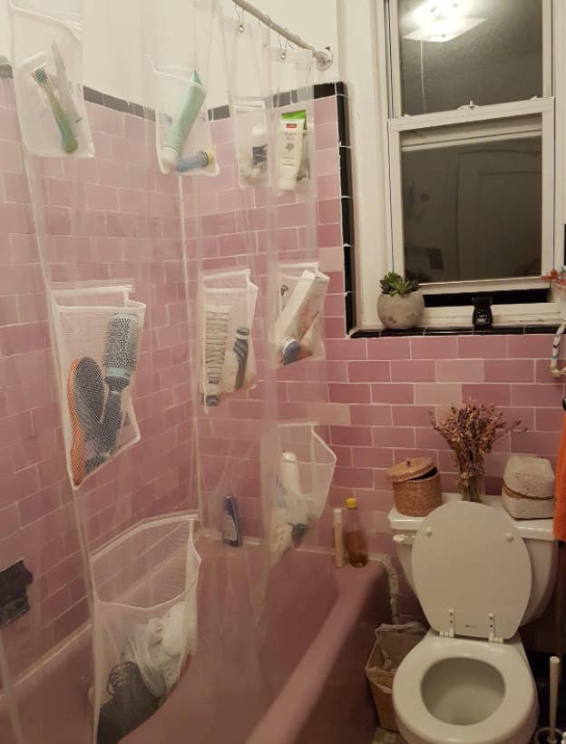 reviewer's bathroom with shower curtain exposed and pockets filled