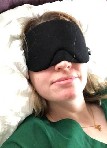reviewer wearing eye mask in bed 