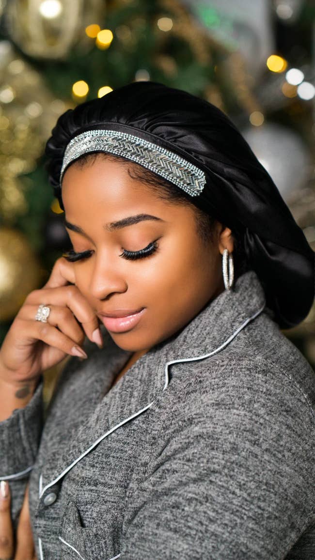 model wearing black silk bonnet with beads on the brim