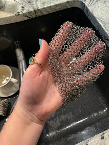 image of reviewer holding up the stainless steel cast iron cleaner